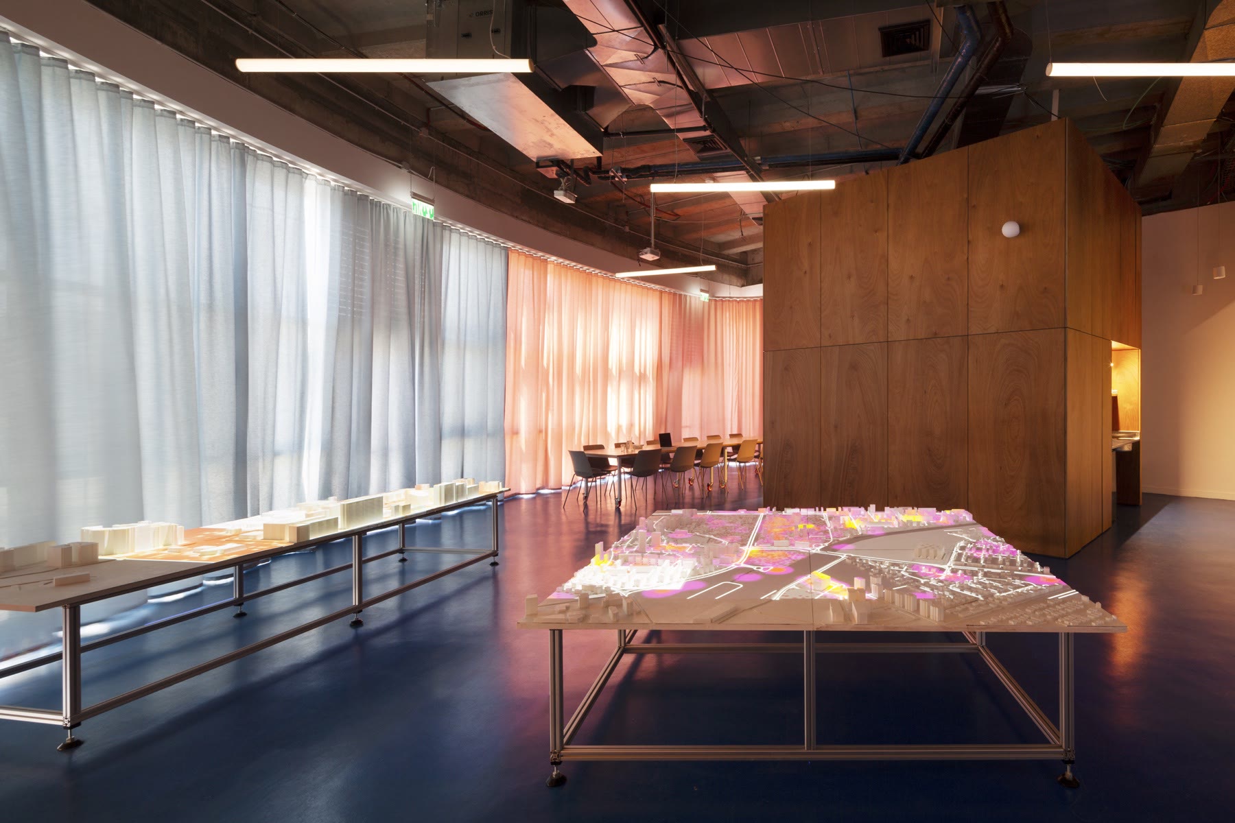 NUR lab interior with illuminated urban models